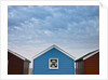 Beach huts in a row against sky by Assaf Frank